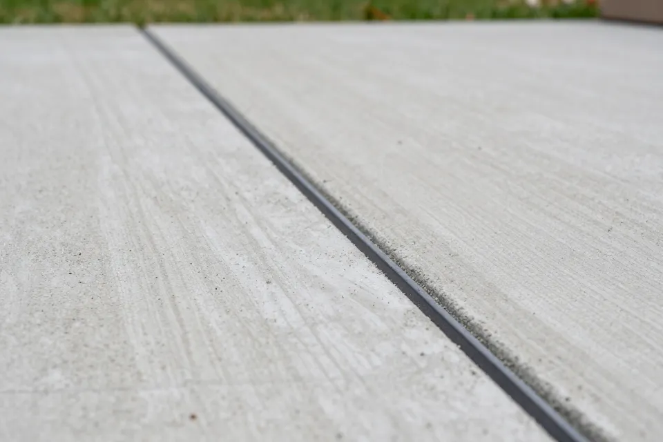 How much should a backyard concrete patio slope away from the house?